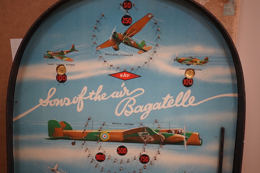 WWII aviation interest; a 1940s bagatelle table pinball game by Kay, Made in England, entitled ‘Sons of the Air’, of hardboard construction, with applied paper surface with images of 1940s RAF aircraft, including a Hawke